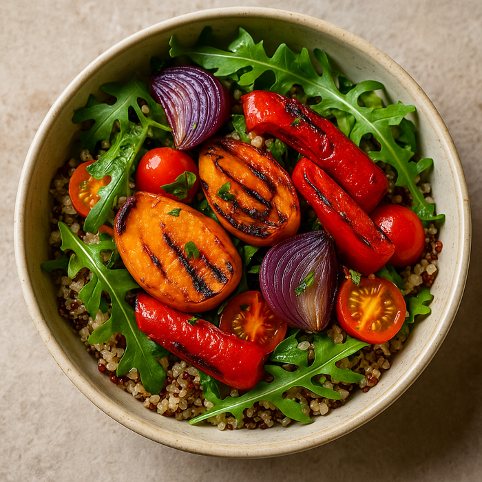 Quinoa salad with roasted vegetables and lemon wedge on a ceramic plate