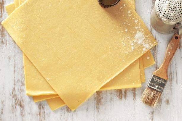 Fresh sambosa leaves on a wooden surface, showing their delicate texture and rich colour in natural light
